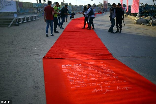 Palestinians on the red carpet, bearing the outline of the Balfour Declaration, during a film festival in Gaza City on May 12, 2017